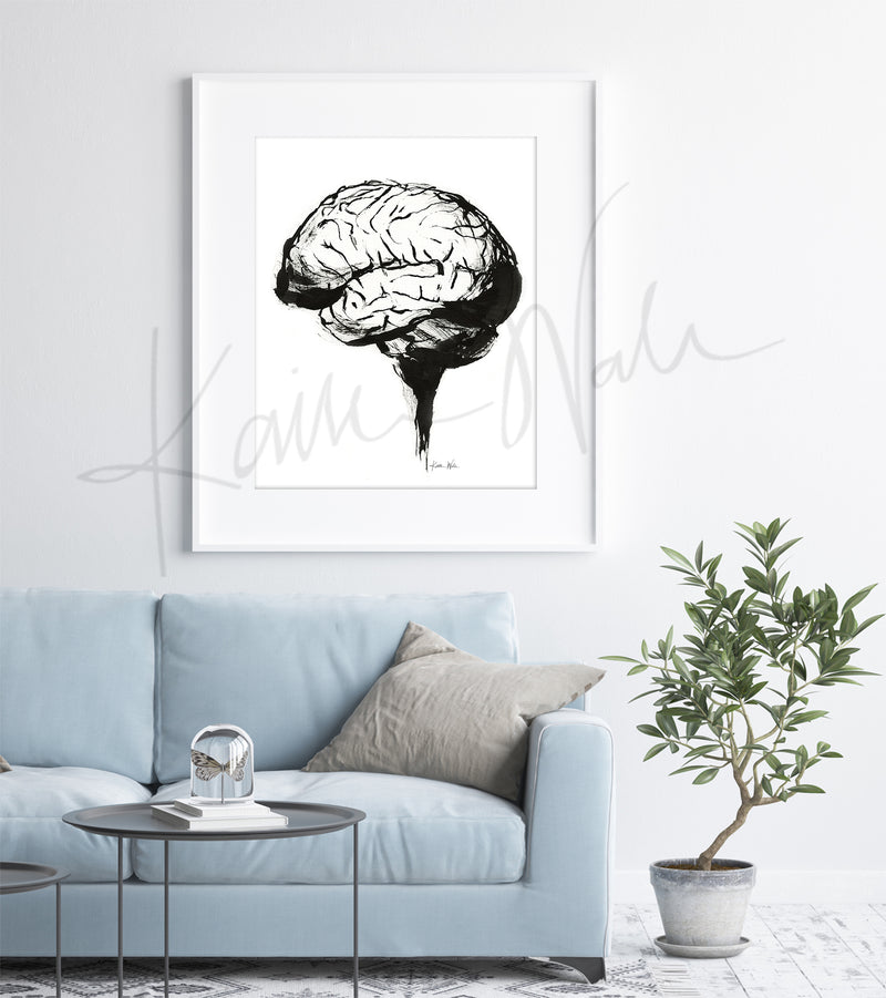 Framed artwork of a brain on a wall above a light blue sofa in a clinic.