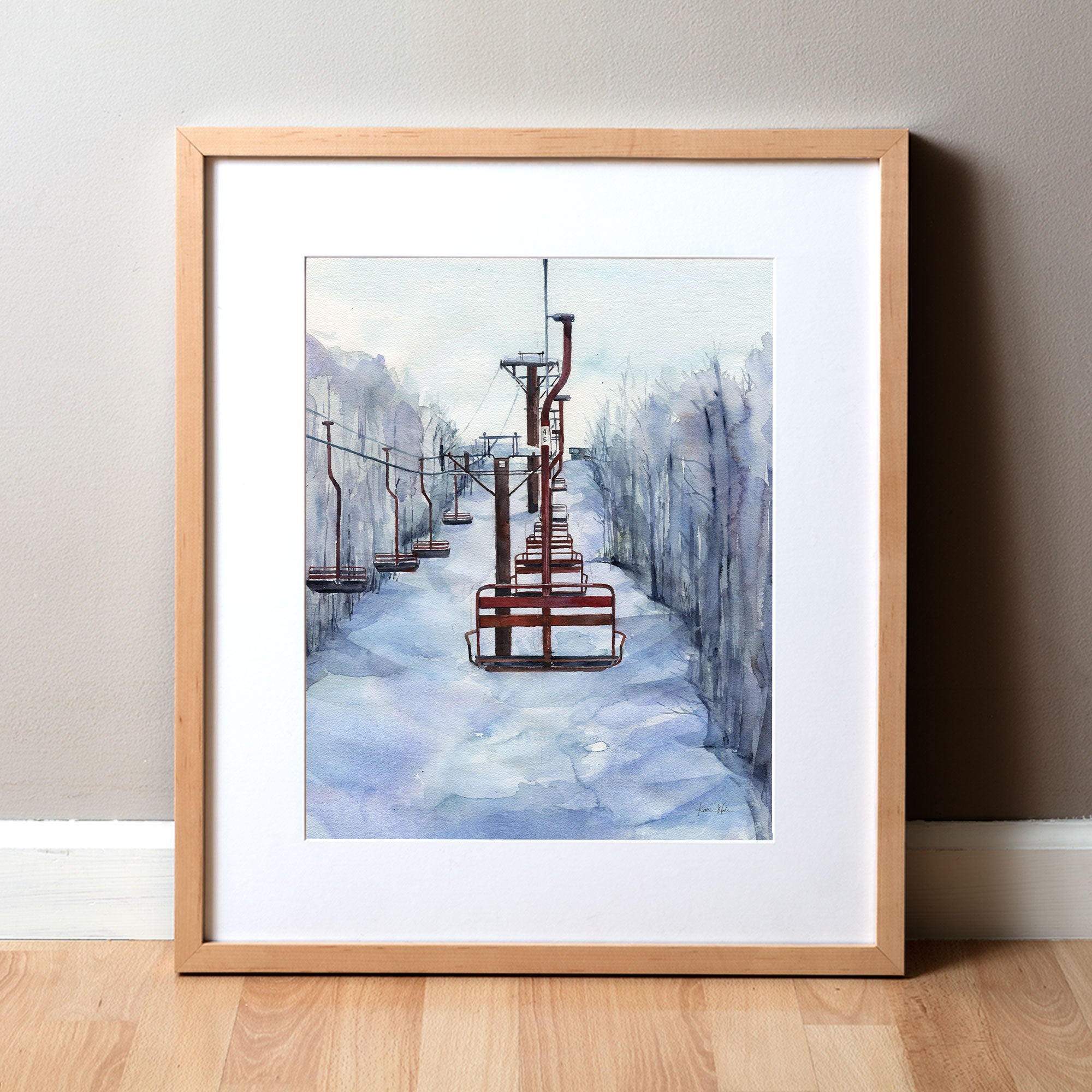 Framed watercolor painting of chairlifts in a snowy scene.
