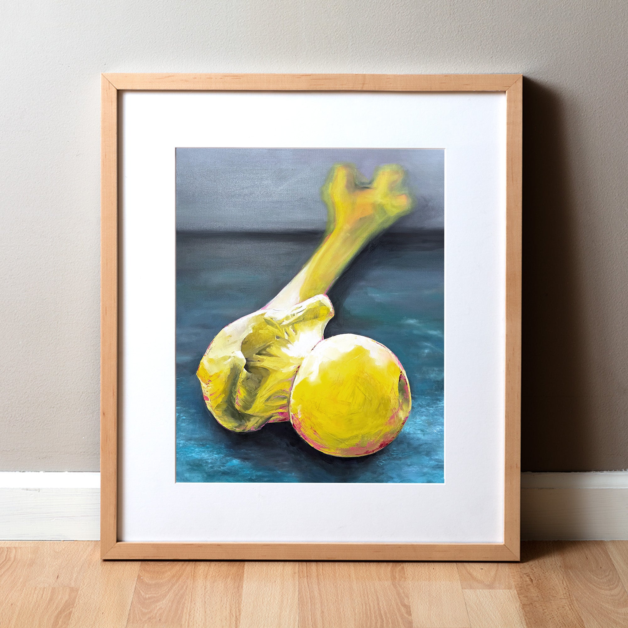 Framed anatomy artwork of a yellow femur bone on a blue background