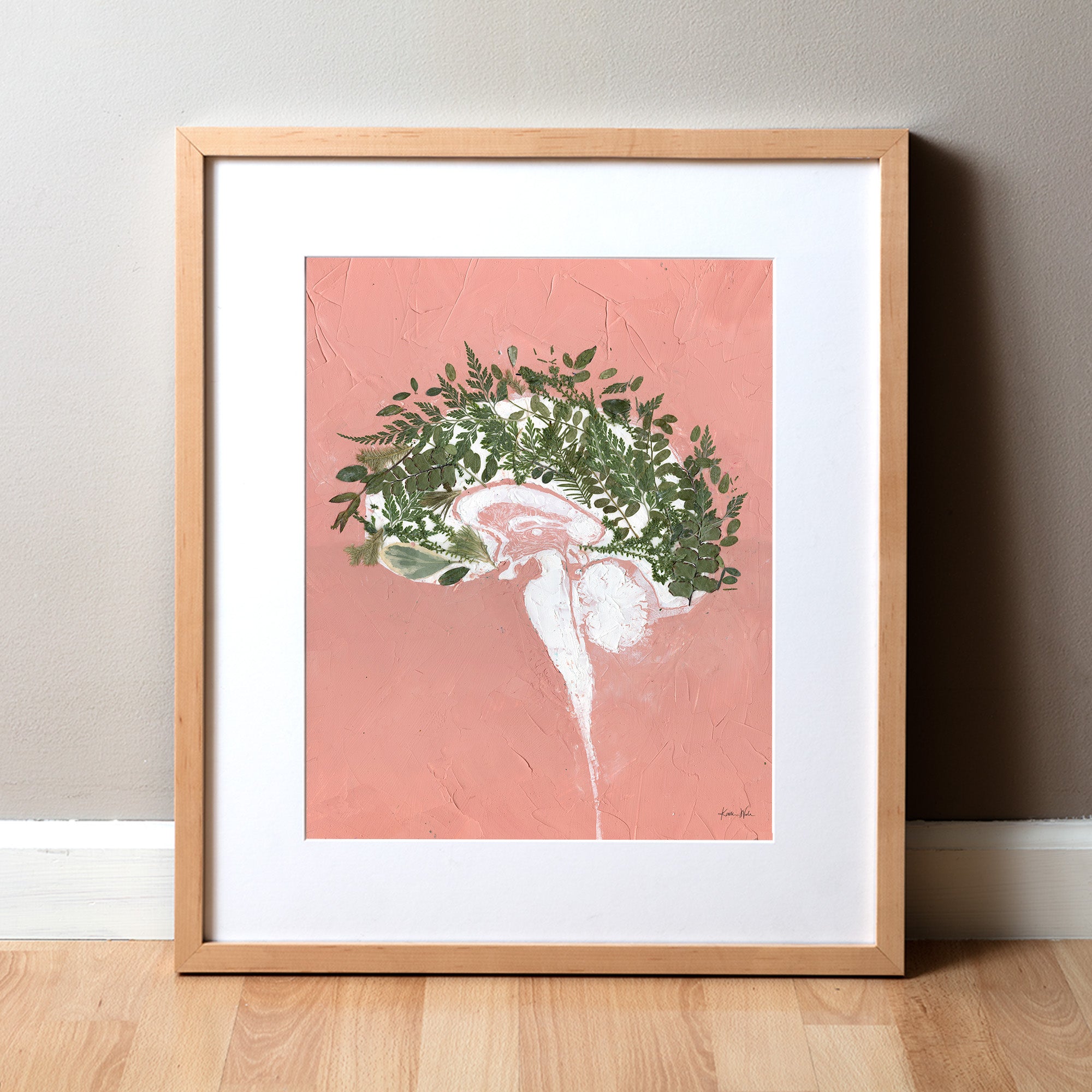 Framed artwork called "Grow" with a white brain with leaves on a pink background. Abstract anatomy art that is great for mental health advocates and doctor's offices and neurologists.