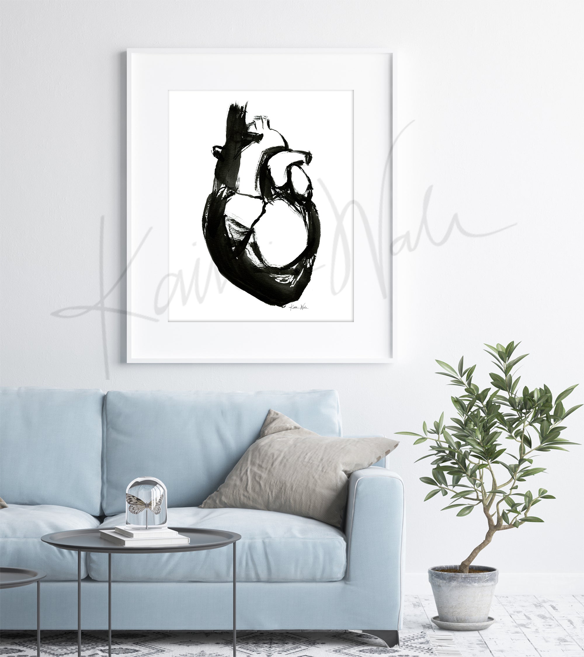 Framed black and white abstract anatomy art of heart anatomy art piece on a wall above a light blue sofa.
