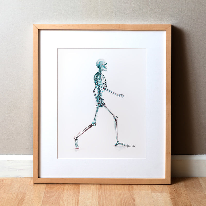 Framed anatomy artwork of a walking skeleton in blue and teal on a white background