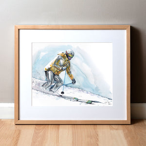 Framed watercolor painting of a skier going down a ski hill with their muscle anatomy showing under their clothing. 