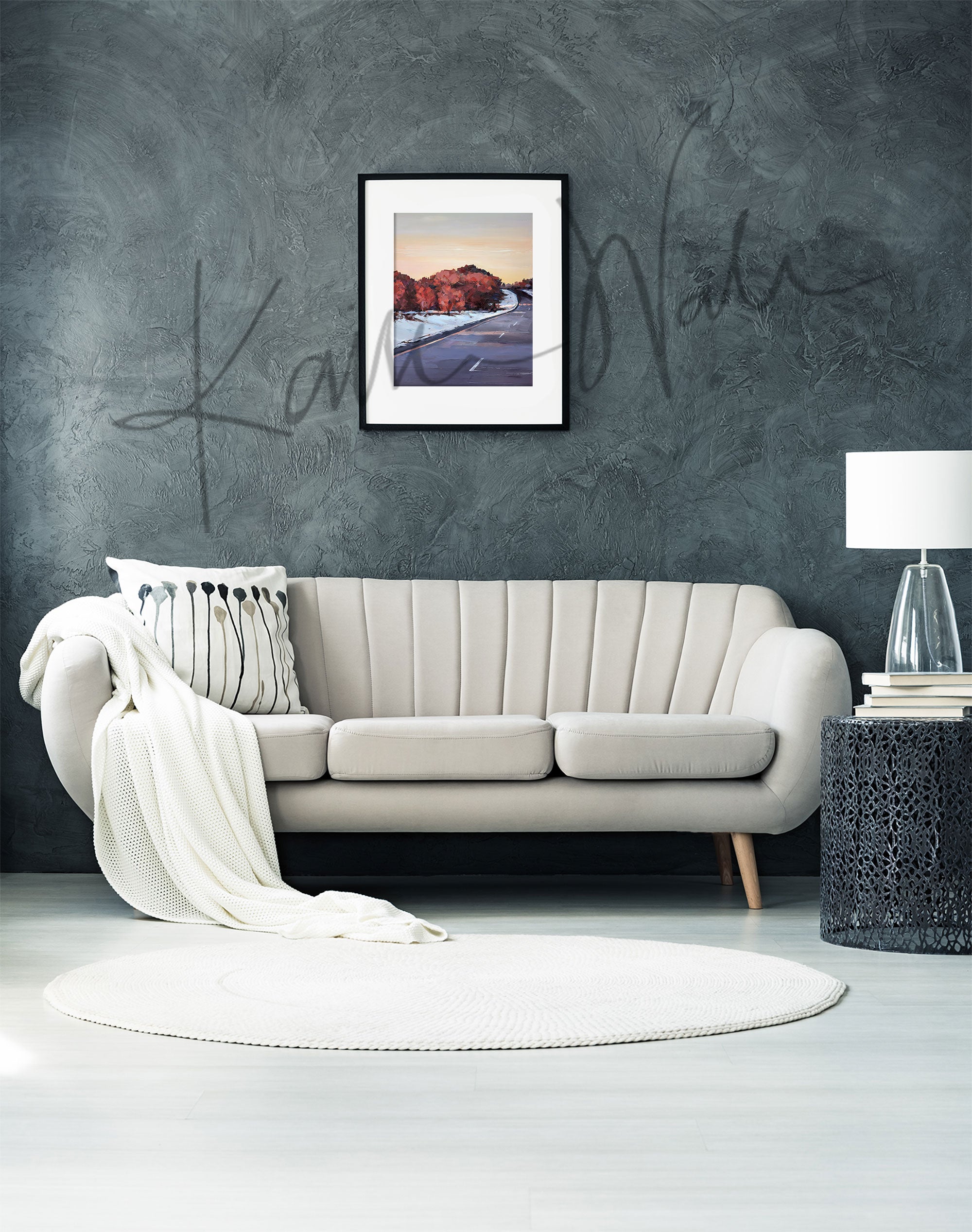 Framed watercolor painting of a snowy Wisconsin landscape in the spring. The painting is hanging over a white couch.