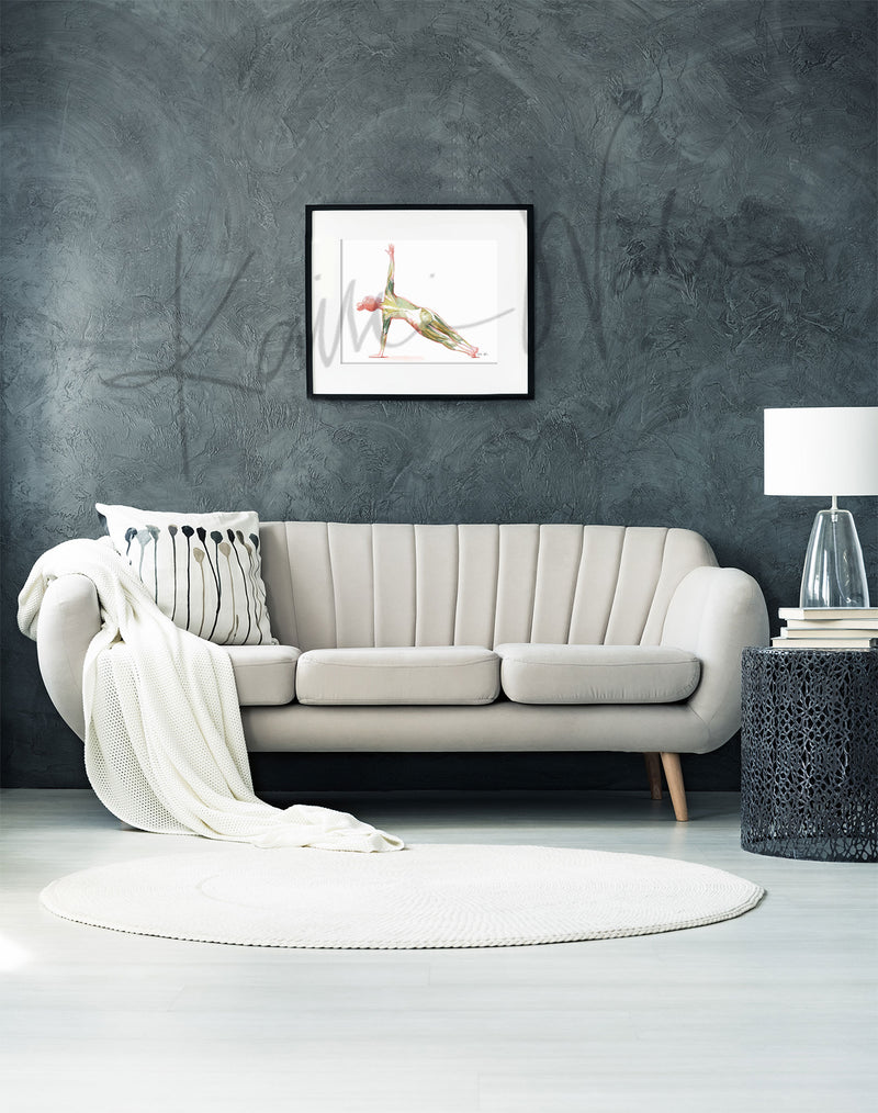 Framed watercolor painting of a woman performing the side plank yoga pose. The image shows her muscular anatomy while doing the pose. The painting is hanging over a white couch.