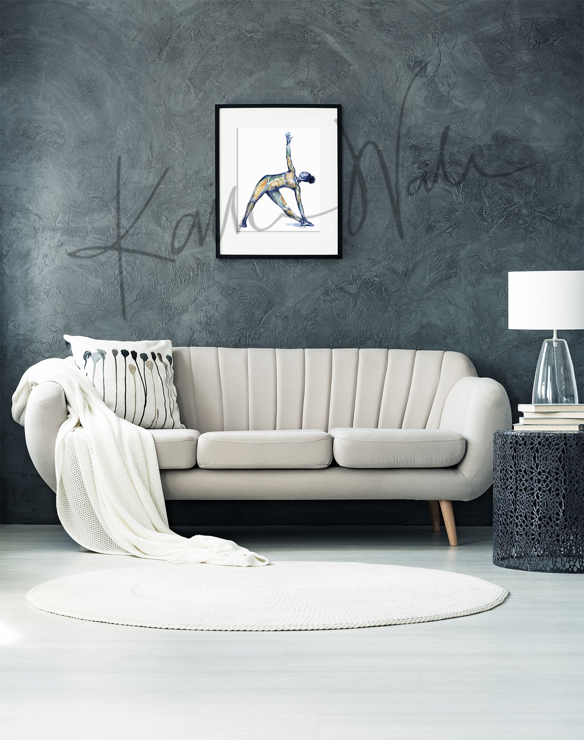 Framed watercolor painting of a woman doing a triangle yoga pose with her muscular system showing beneath her skin. The painting is hanging over a white couch.