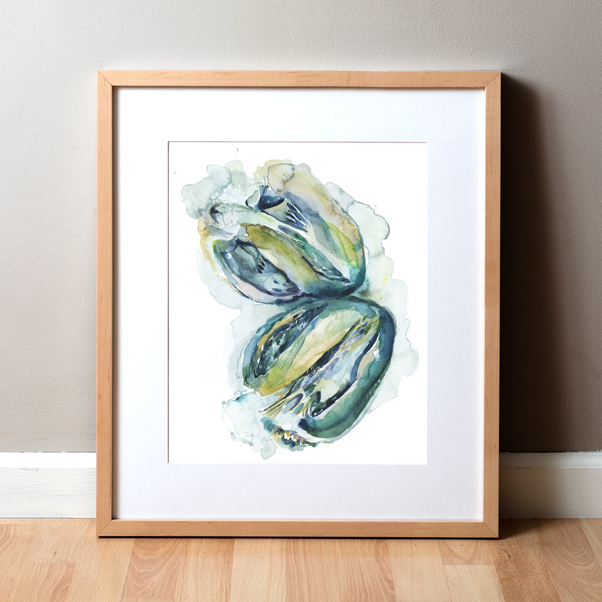 Framed watercolor painting of a heart dissection in greens blues and yellows.