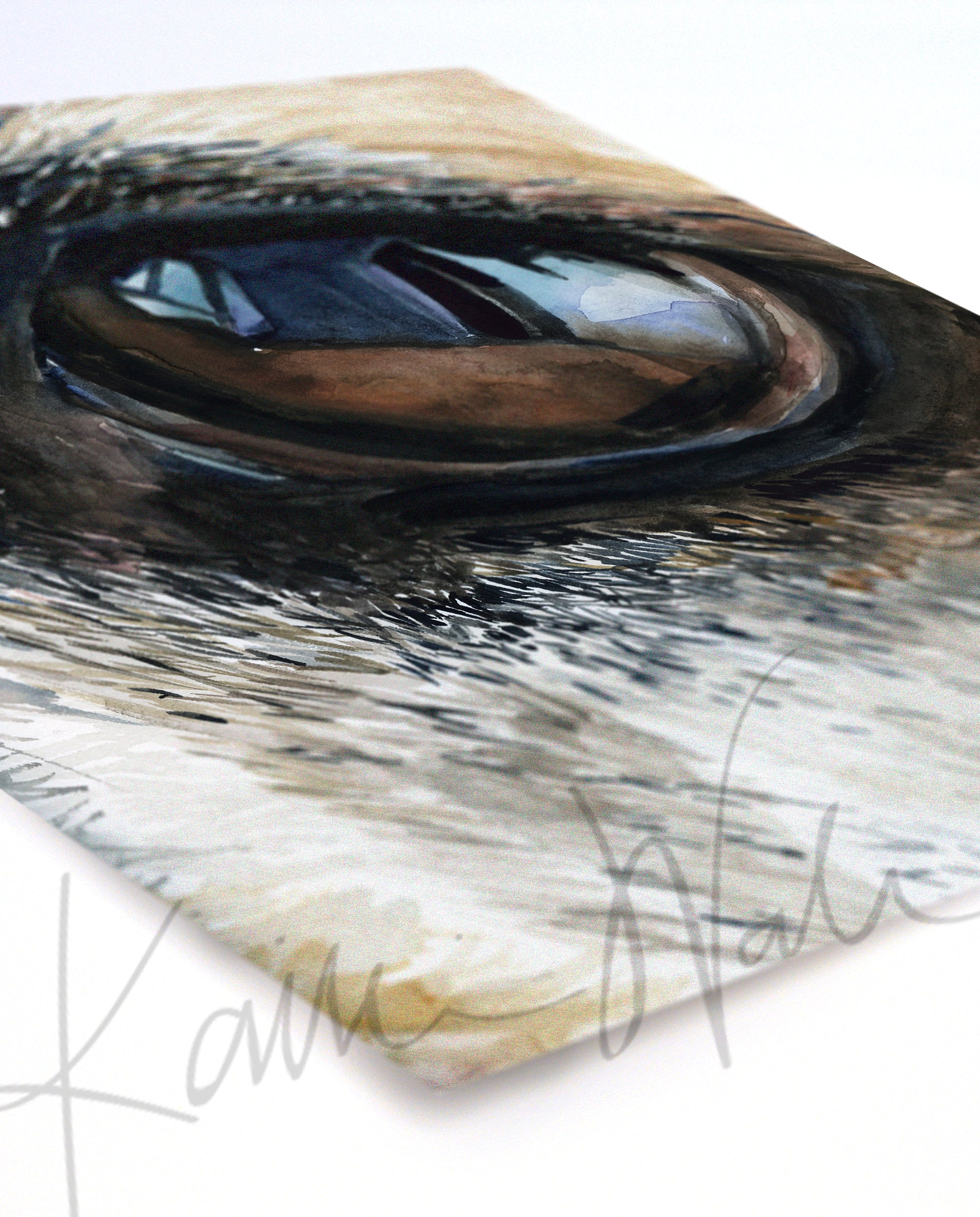 Unframed watercolor painting of a zoomed in perspective of a dog’s eye. The painting is in blacks, tans, and browns and is at an angle.