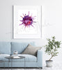 Framed watercolor painting of a platelet. The painting is hanging over a blue couch.