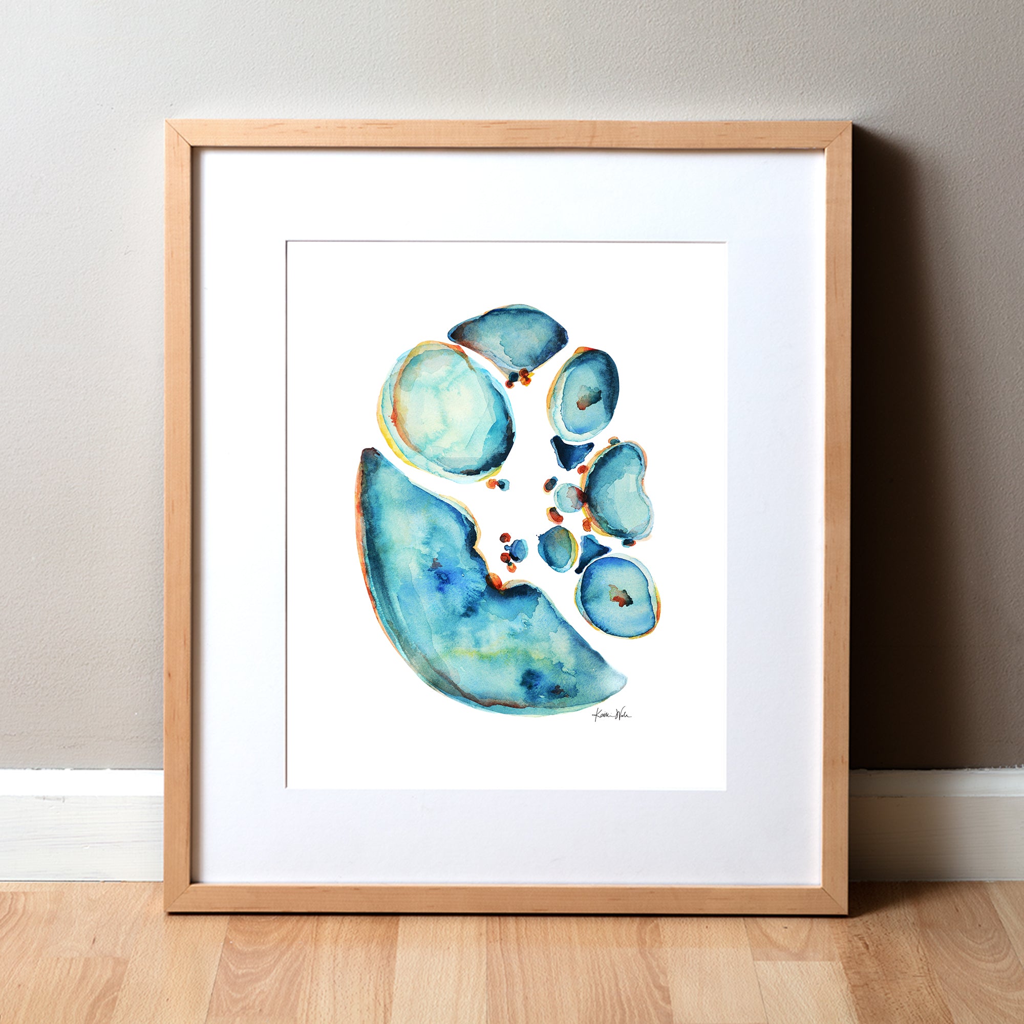 Framed watercolor painting showing a cross section of an abdomen in blues and teals with pops of orange and yellow.