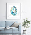 Framed watercolor painting showing a cross section of an abdomen in blues and teals with pops of orange and yellow. The painting hangs above a blue couch.