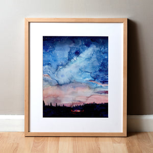 Framed watercolor painting of a bonfire, night sky, and silhouetted trees.
