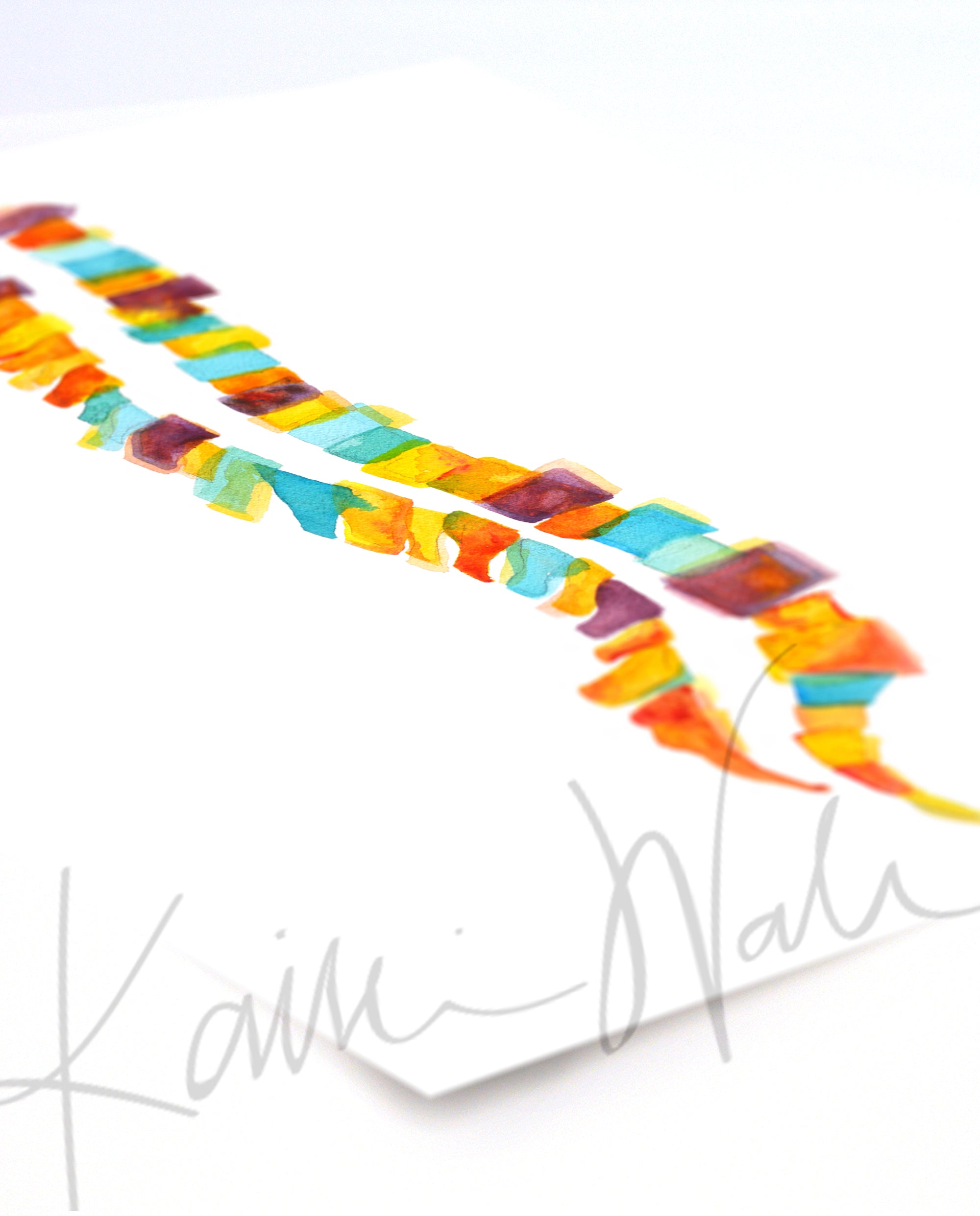 Unframed watercolor painting of a spinal columns in yellow, orange, burgundy and teal. The painting is at an angle.