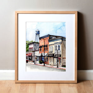 Framed watercolor painting of buildings on Main Street in Waunakee, Wisconsin.