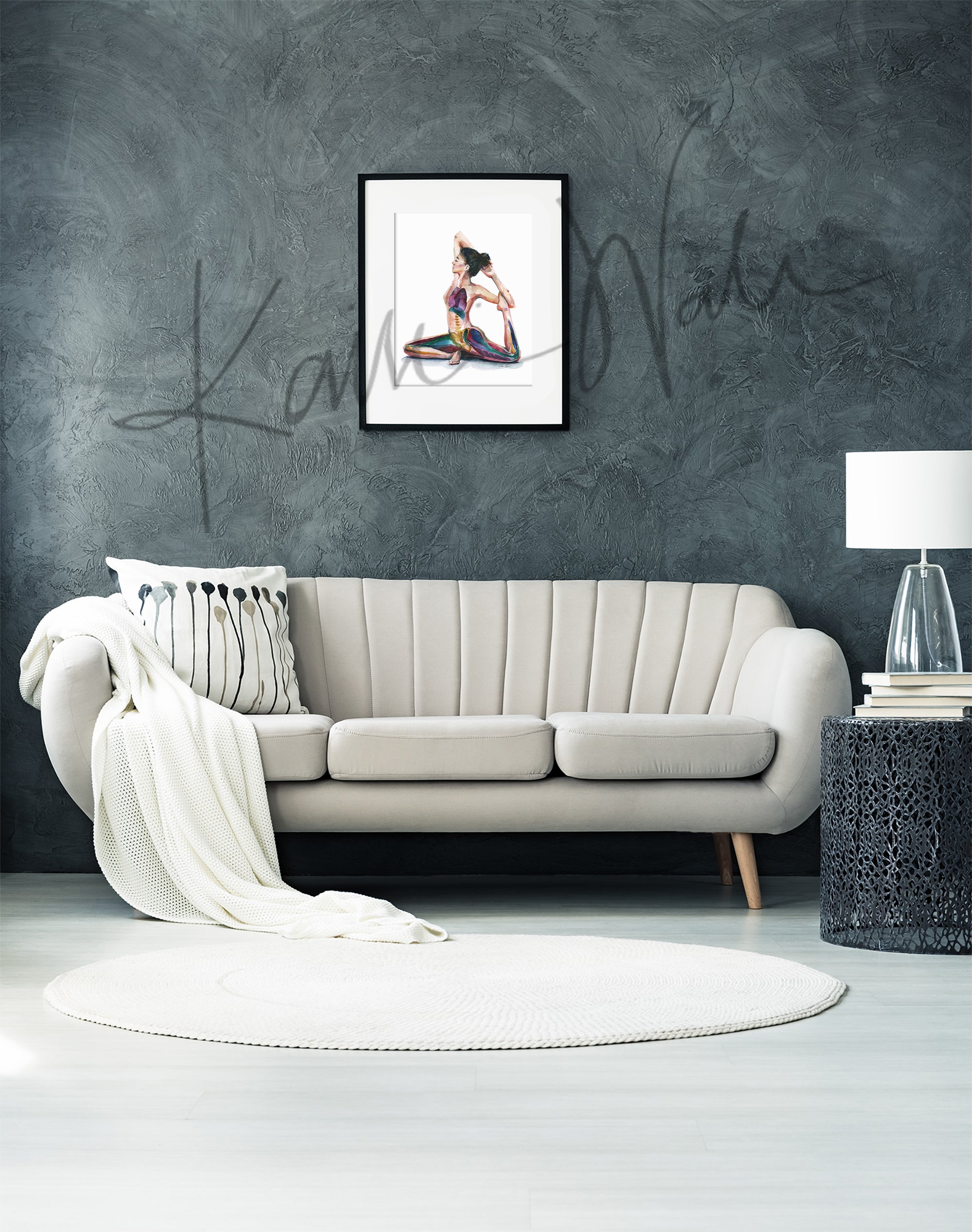 Framed watercolor painting of a woman with her eyes closed in a seated yoga position stretching her leg behind her. The painting is hanging over a white couch.