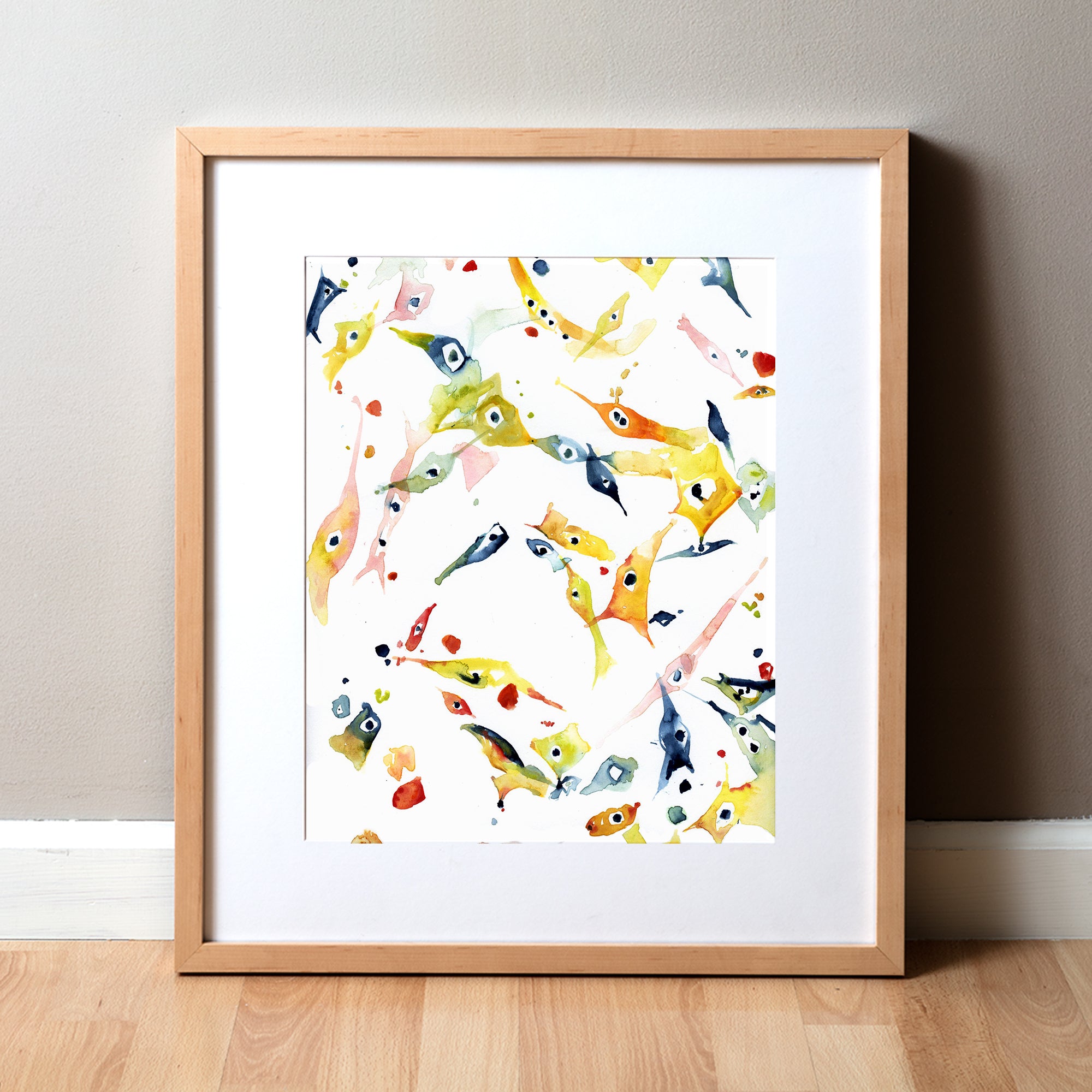 Framed watercolor painting of mesenchymal stem cells in oranges, greens, pinks, and navy blues.