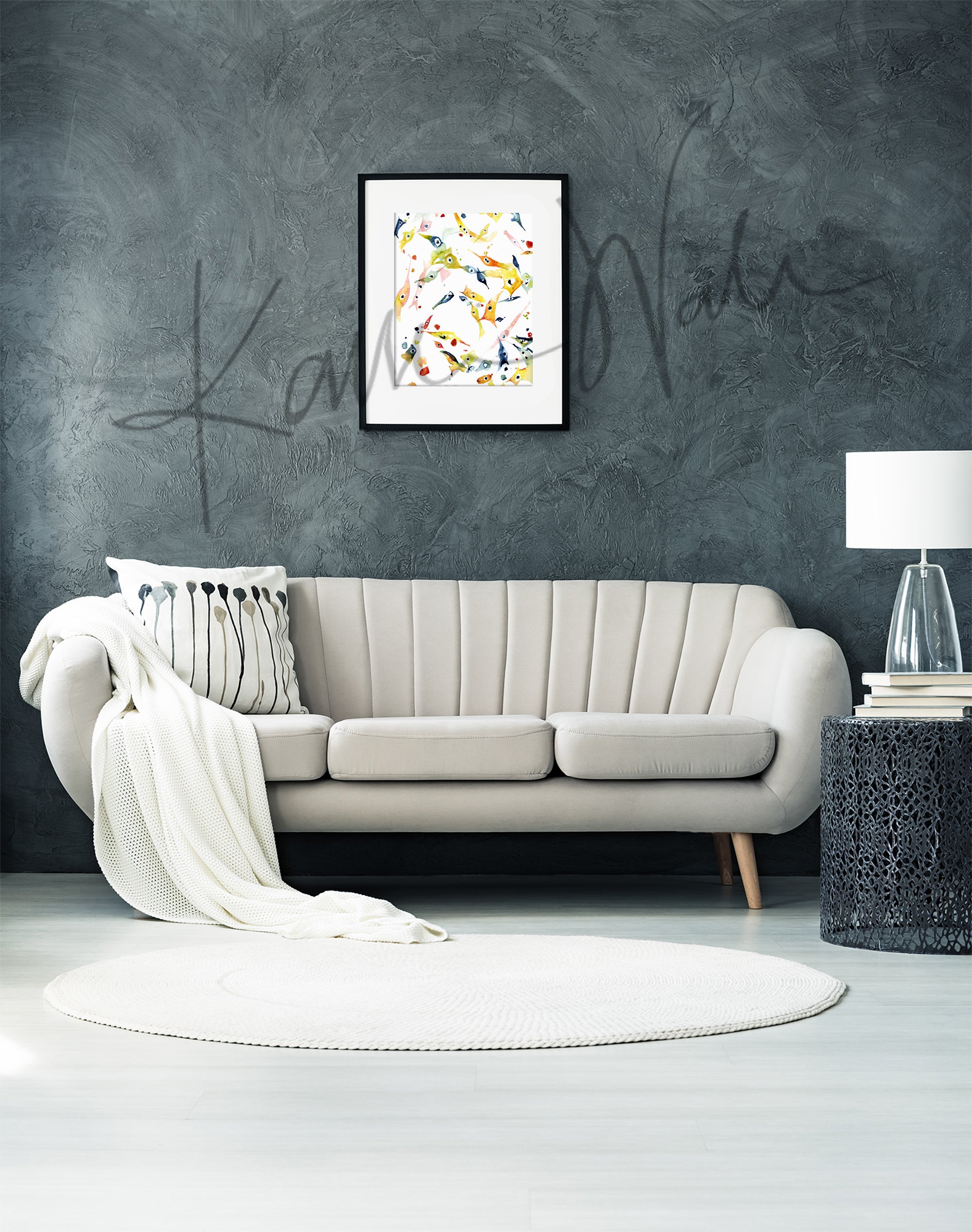 Framed watercolor painting of mesenchymal stem cells. The painting is hanging over a beige couch.