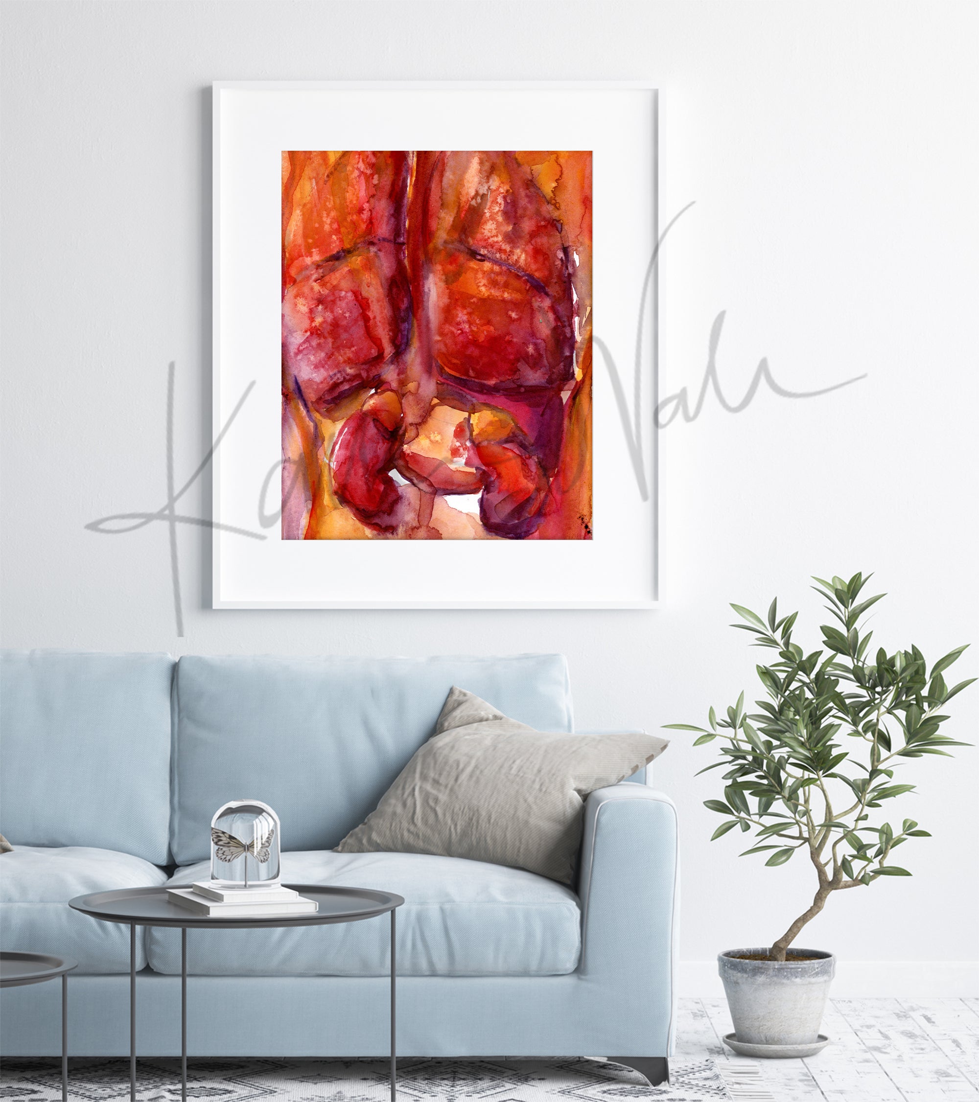 Framed watercolor painting of the internal trunk organs in reds and oranges.. The painting is hanging over a blue couch. 