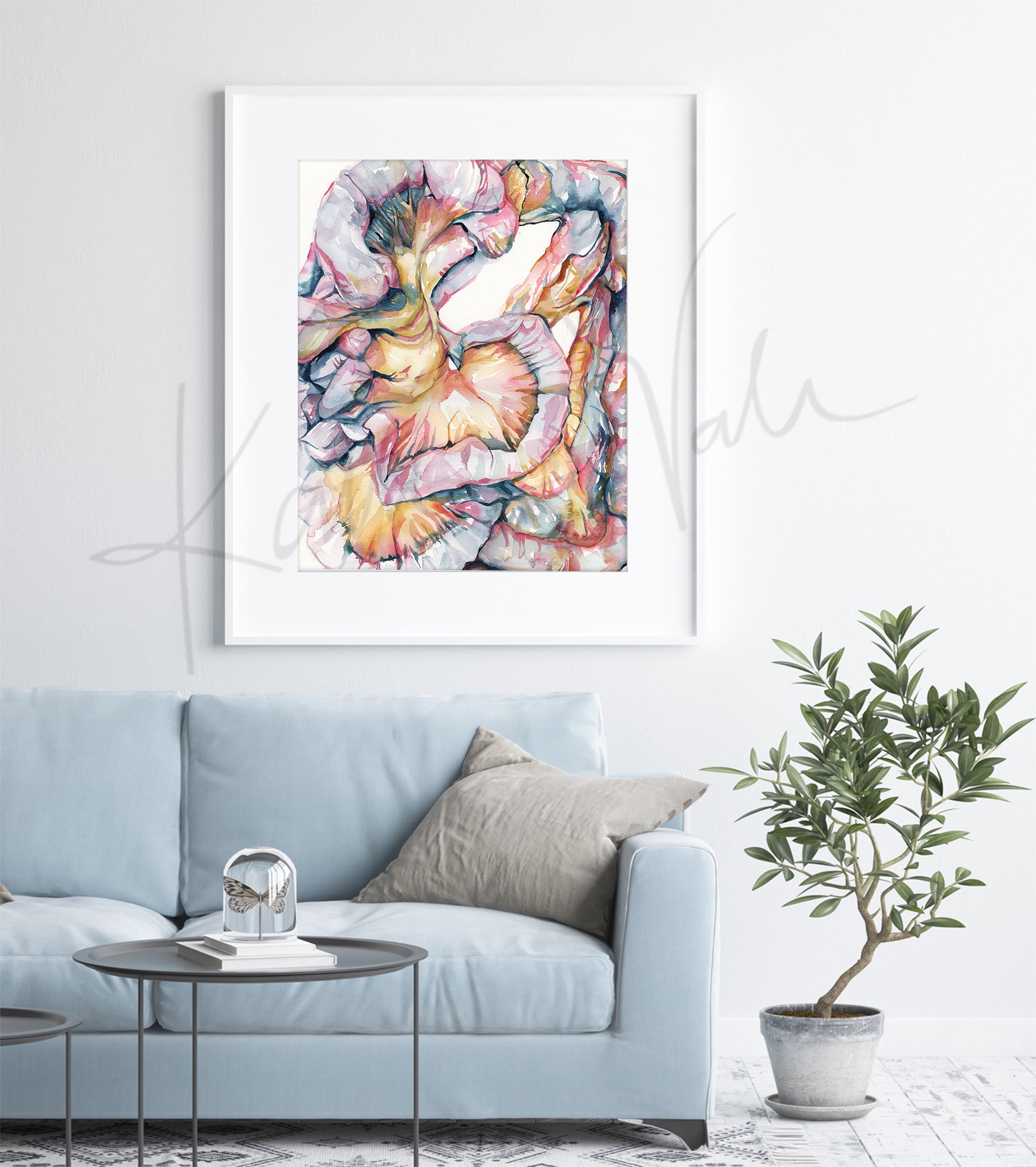 Framed watercolor painting of the intestines and mesentery folds in soft, light pastels. The painting is hanging over a blue couch.