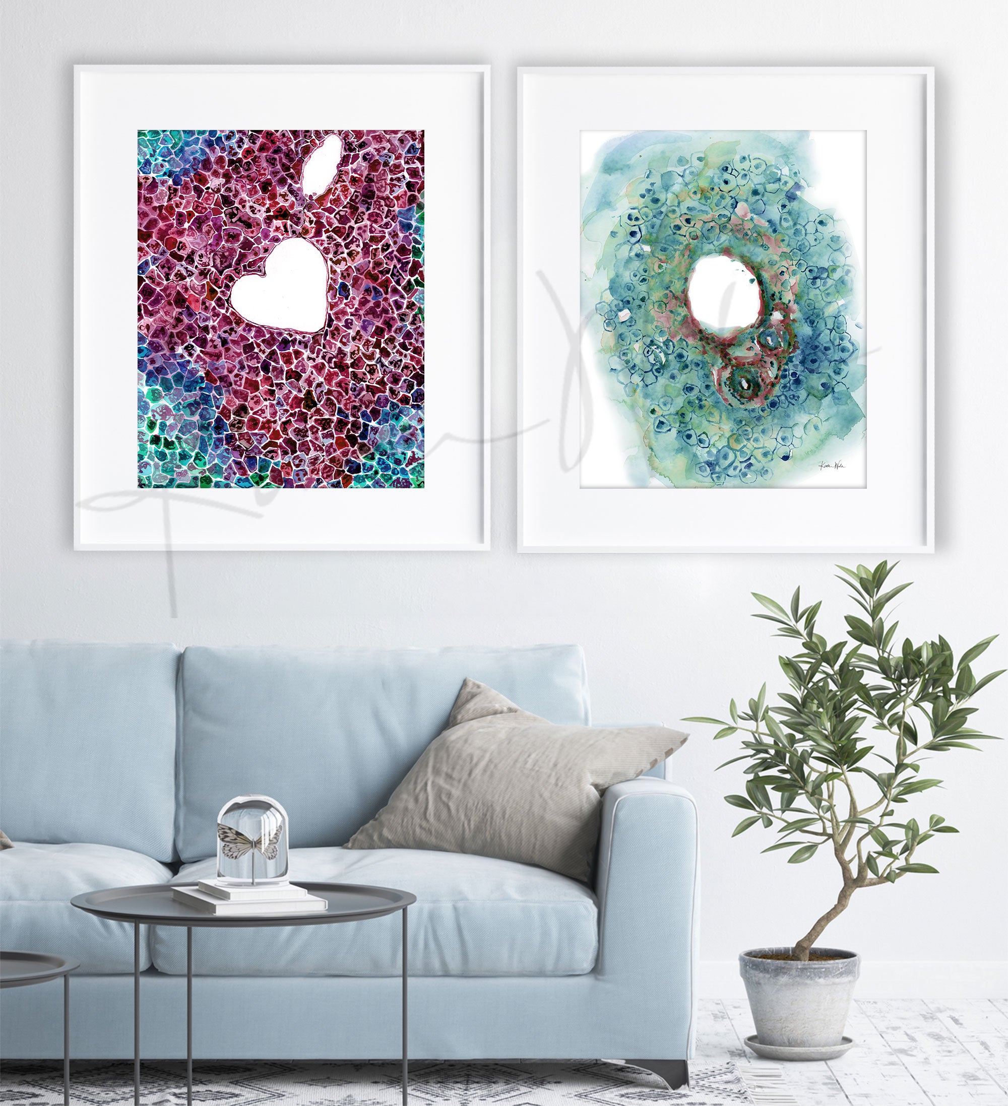Framed watercolor painting set of the bile and hepatic ducts. The paintings are hanging over a blue couch.
