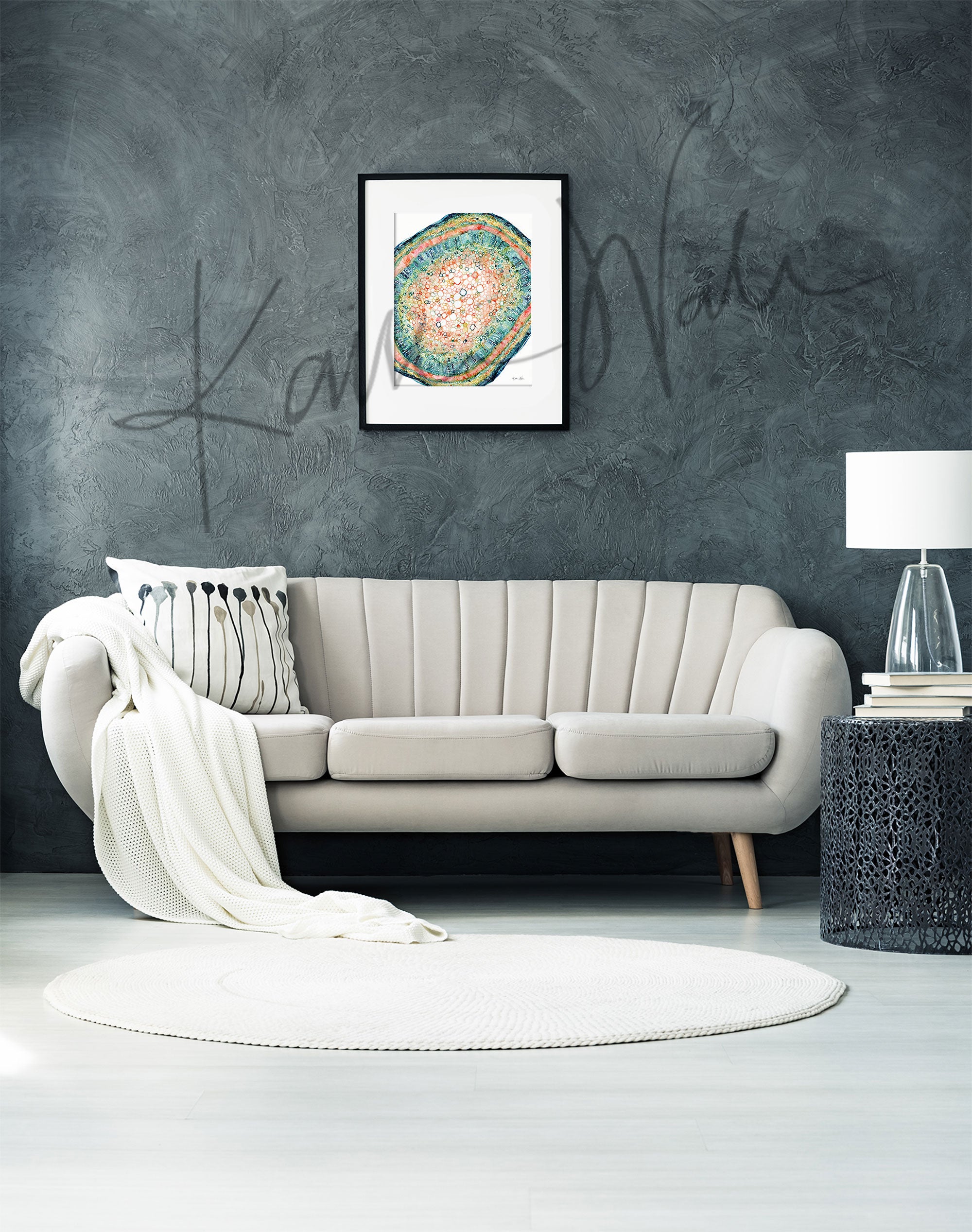Framed watercolor painting of the histology of a plant leaf stem. The painting is hanging over a white couch.
