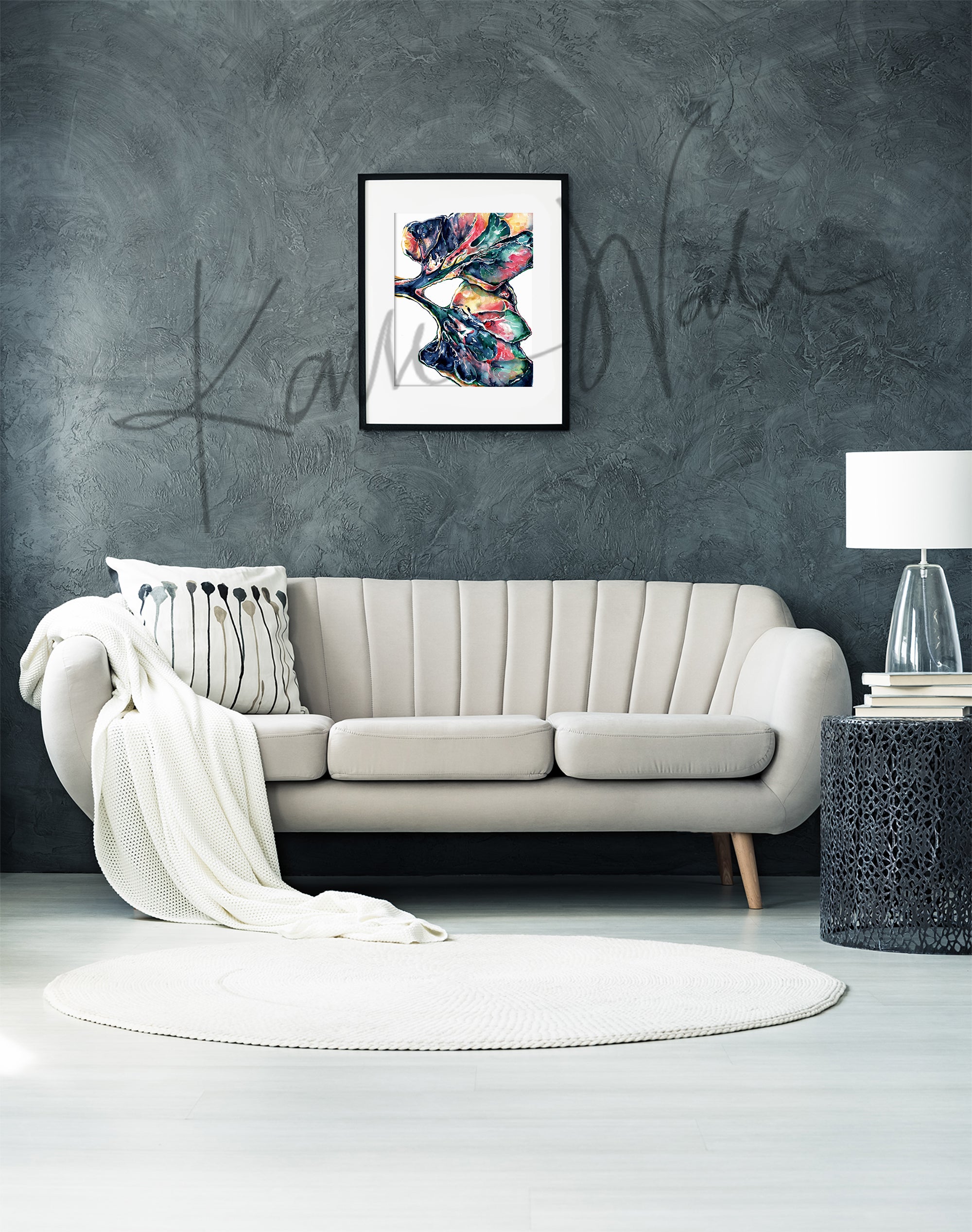 Framed colorful, abstract watercolor painting of a lung dissection in navy, green, yellow, and pink. The painting is hanging over a white couch.