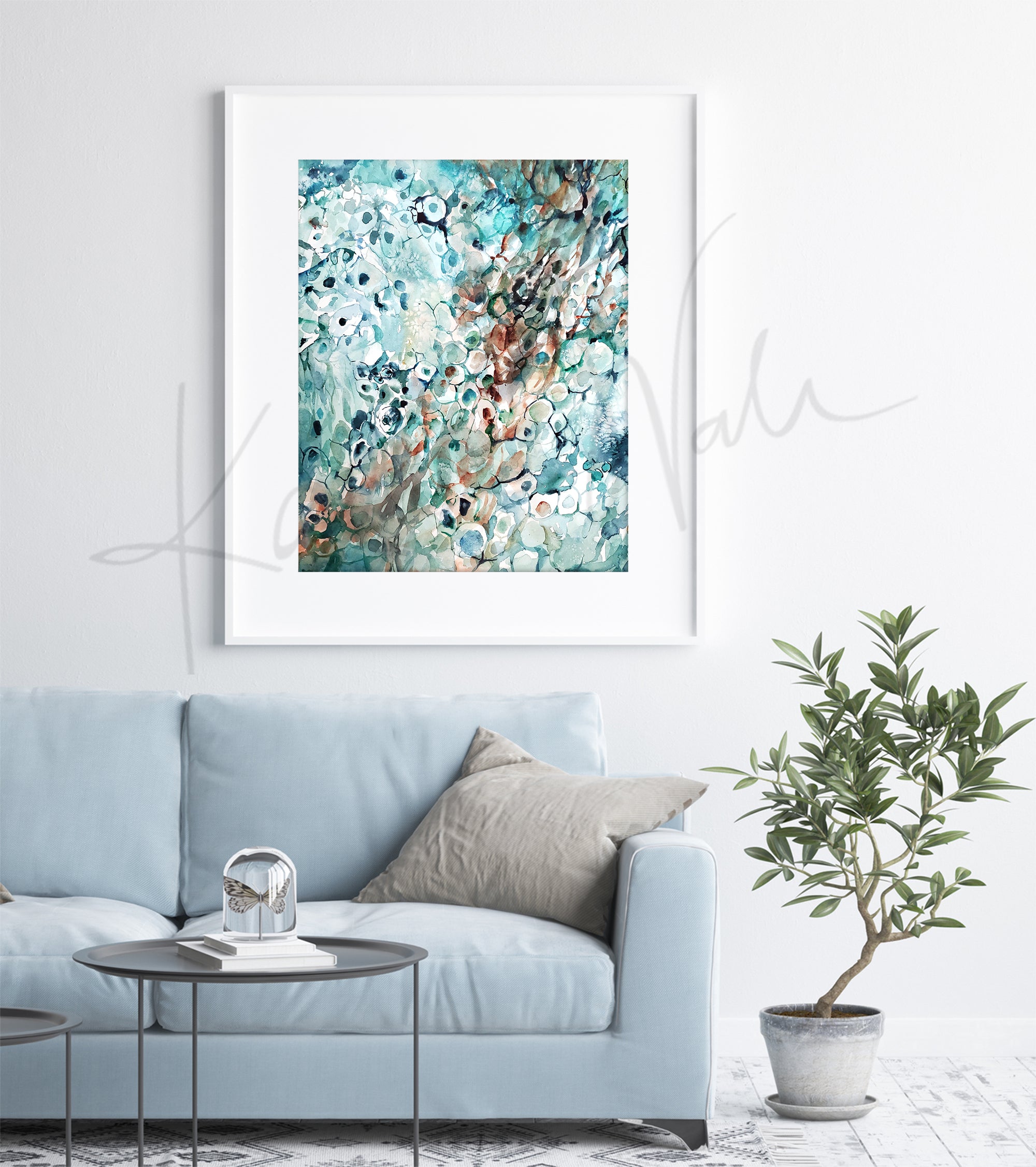 Framed watercolor painting of a histological portrait of melanoma. The painting is hanging over a blue couch.