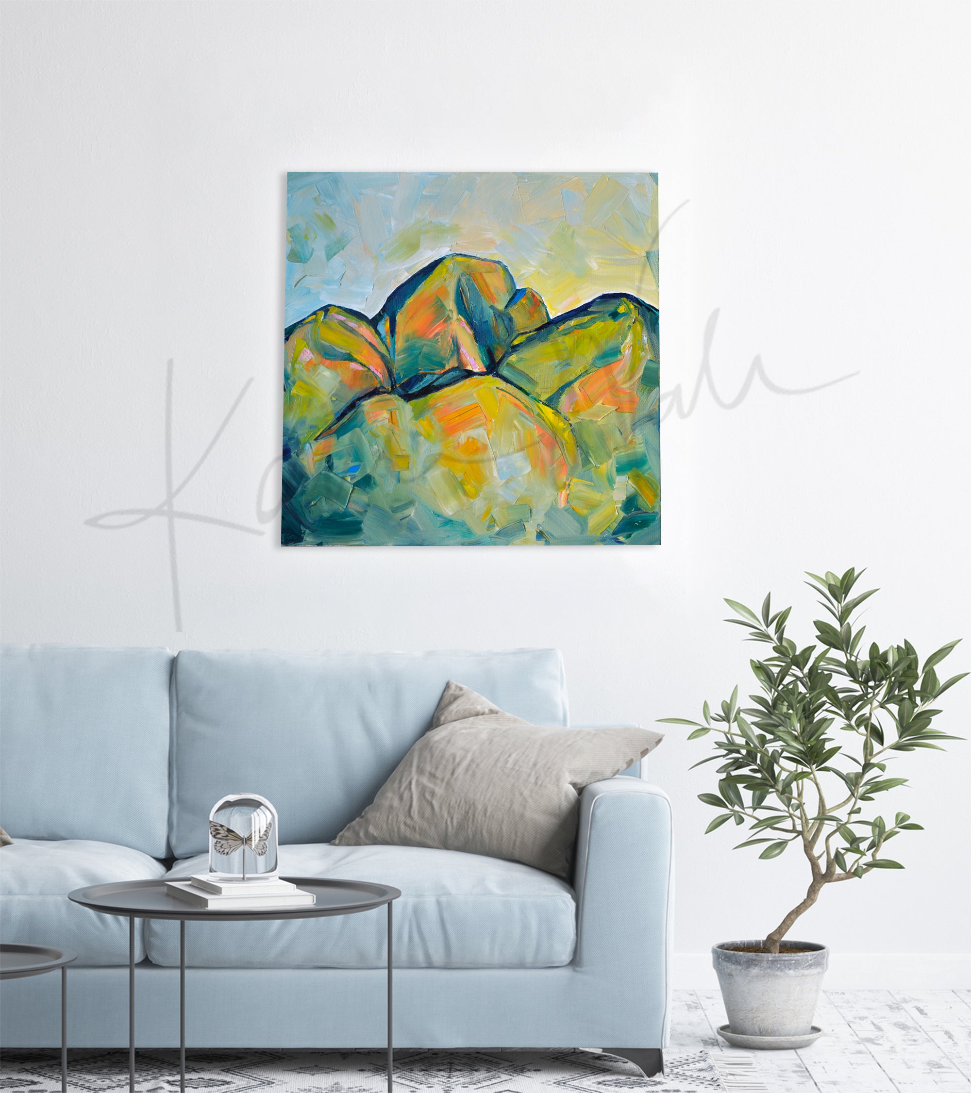 Oil painting of an abstract molar tooth painted to look like mountains. The painting is hanging over a blue couch.
