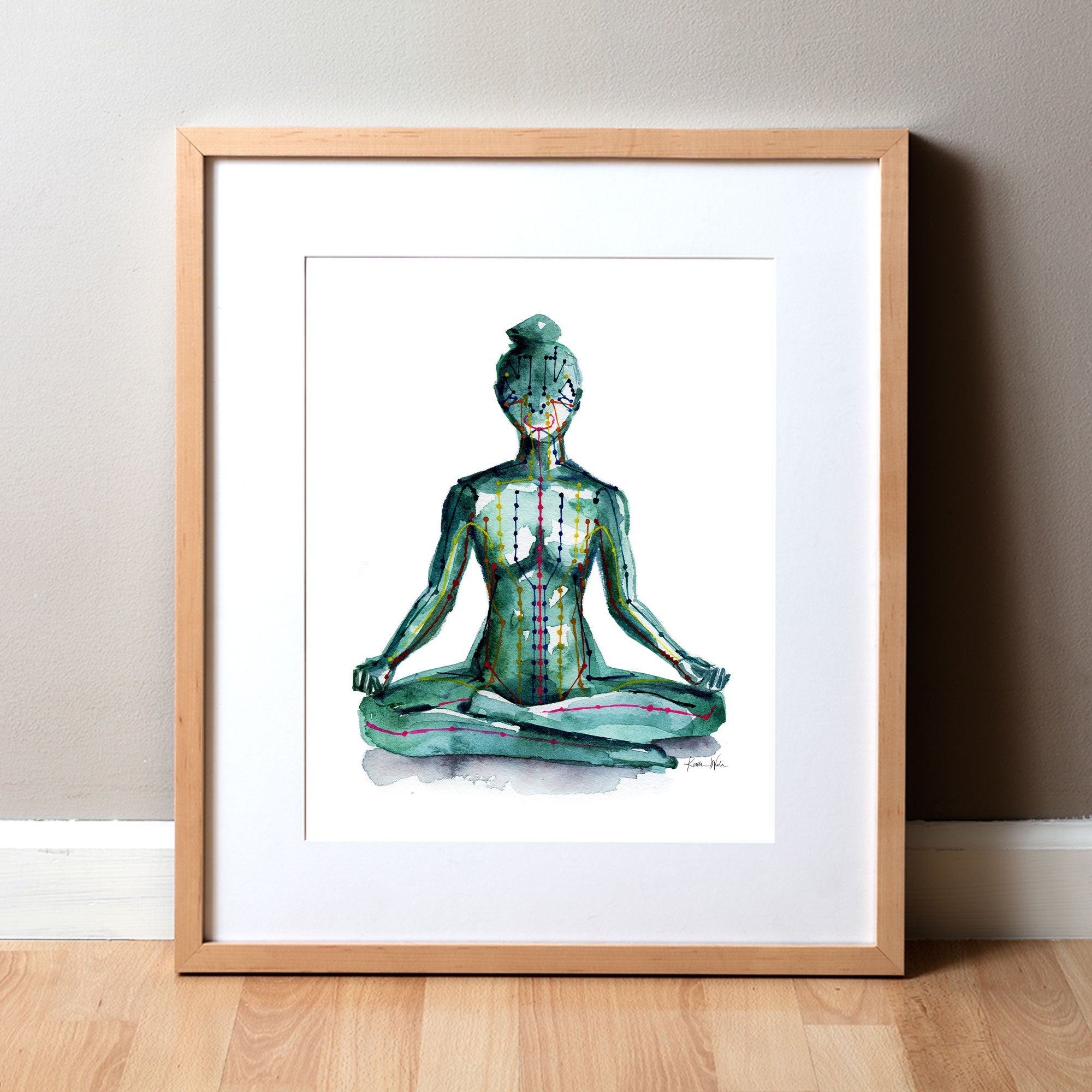 Framed watercolor painting of a person sitting in a meditative pose with meridian paths showing.