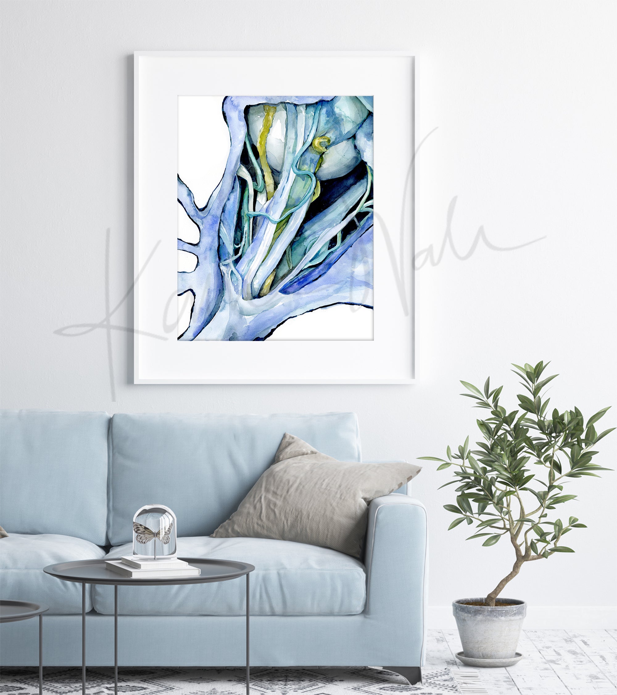 Framed watercolor painting of a dissection showing the orbital nerves and surrounding anatomy in blues, teals, and greens. The painting is hanging over a blue couch.