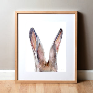 Framed watercolor painting of a zoomed in perspective of rabbit ears in tans, pinks, and browns.