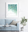 Framed watercolor painting of the tapetum lucidum tissue in animal eyes. The painting is hanging over a blue couch. 