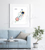Framed watercolor painting of the testosterone hormone molecular structure. The painting is hanging over a blue couch.