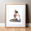 Framed watercolor painting of a woman with her eyes closed in a seated yoga position stretching her leg behind her.